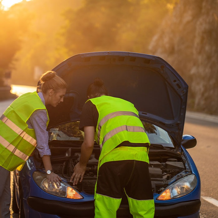 roadside assistance people helping someone on the side of the road
