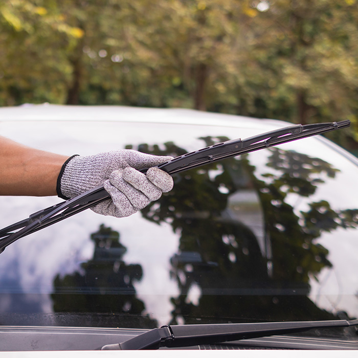 someone inspecting a wiper blade for a car