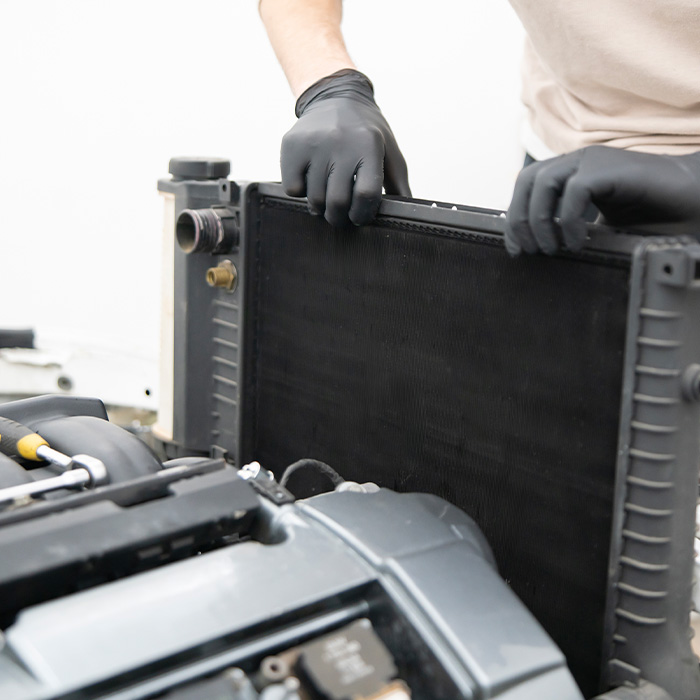someone inspecting a car radiator
