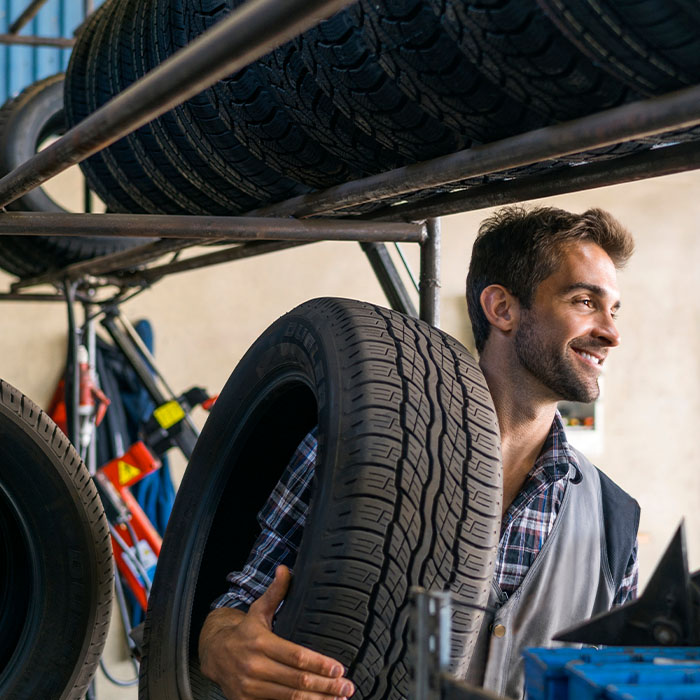 man carrying a tire